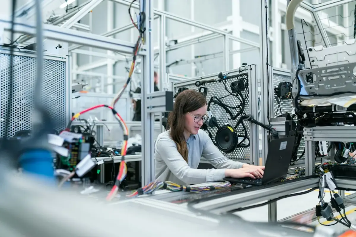 Technology professional working with digital systems in an industrial setting